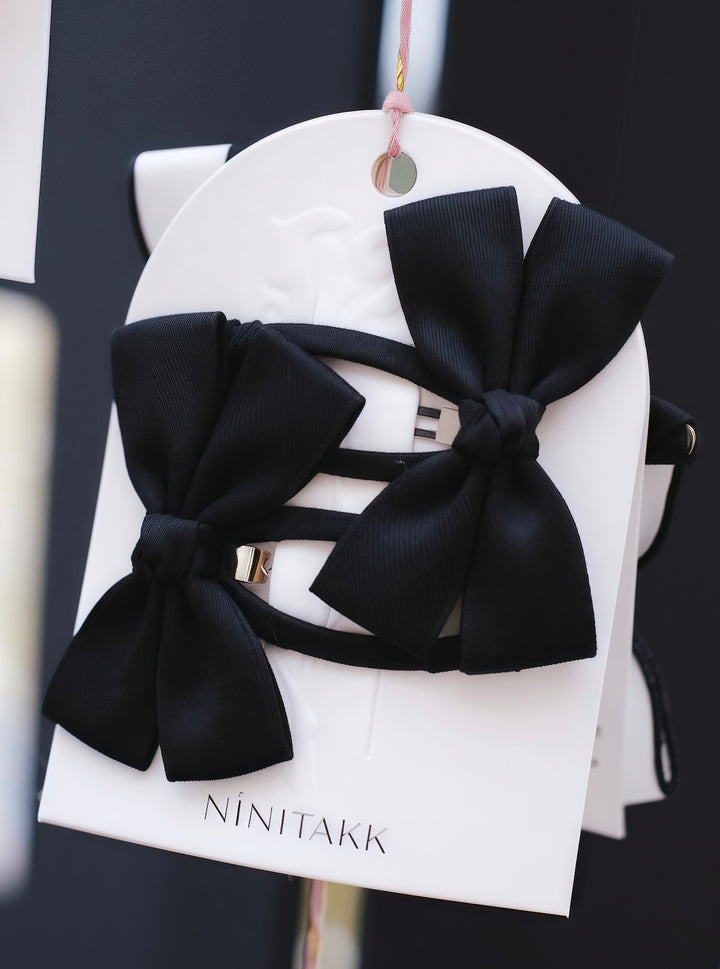 A classic set of black satin bows, versatile for any outfit.