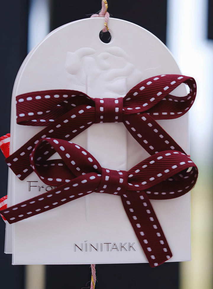 Close-up of the burgundy bow hair clips, highlighting the fine stitching and the secure alligator clips. Ideal for adding a rich, sophisticated color to your child’s look.
