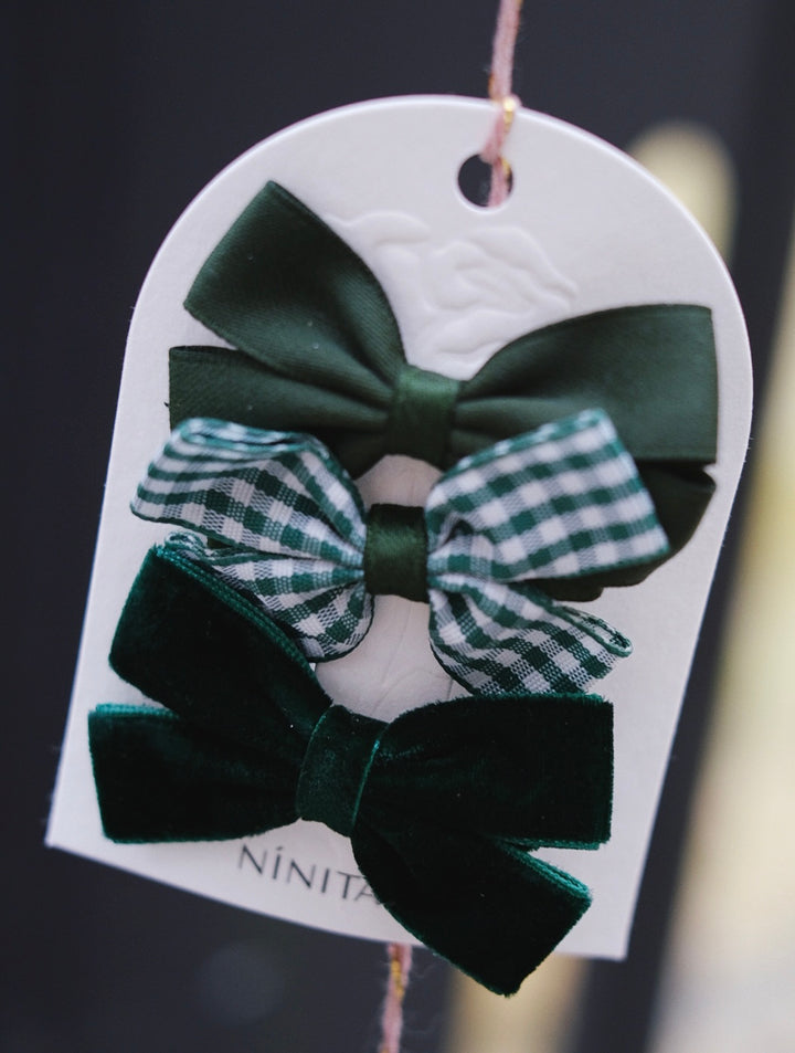 A vibrant mix of green bows, including a charming checkered design for a playful and stylish appearance.