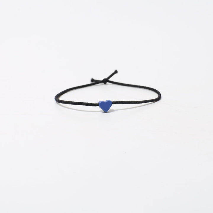 The Tiny Heart hair tie in a rich blue color.