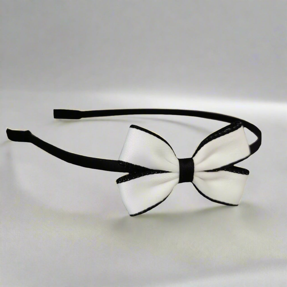 A chic headband adorned with a small, elegant white bow, ideal for everyday wear and special occasions. The bow is approximately 6 cm in size, offering a cute and subtle look.