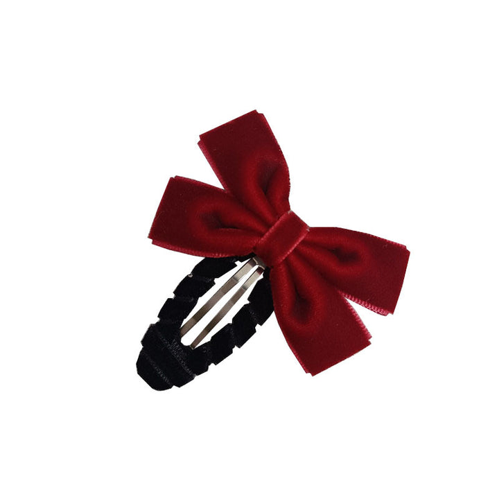 A rich red velvet bow, exuding luxury and elegance.