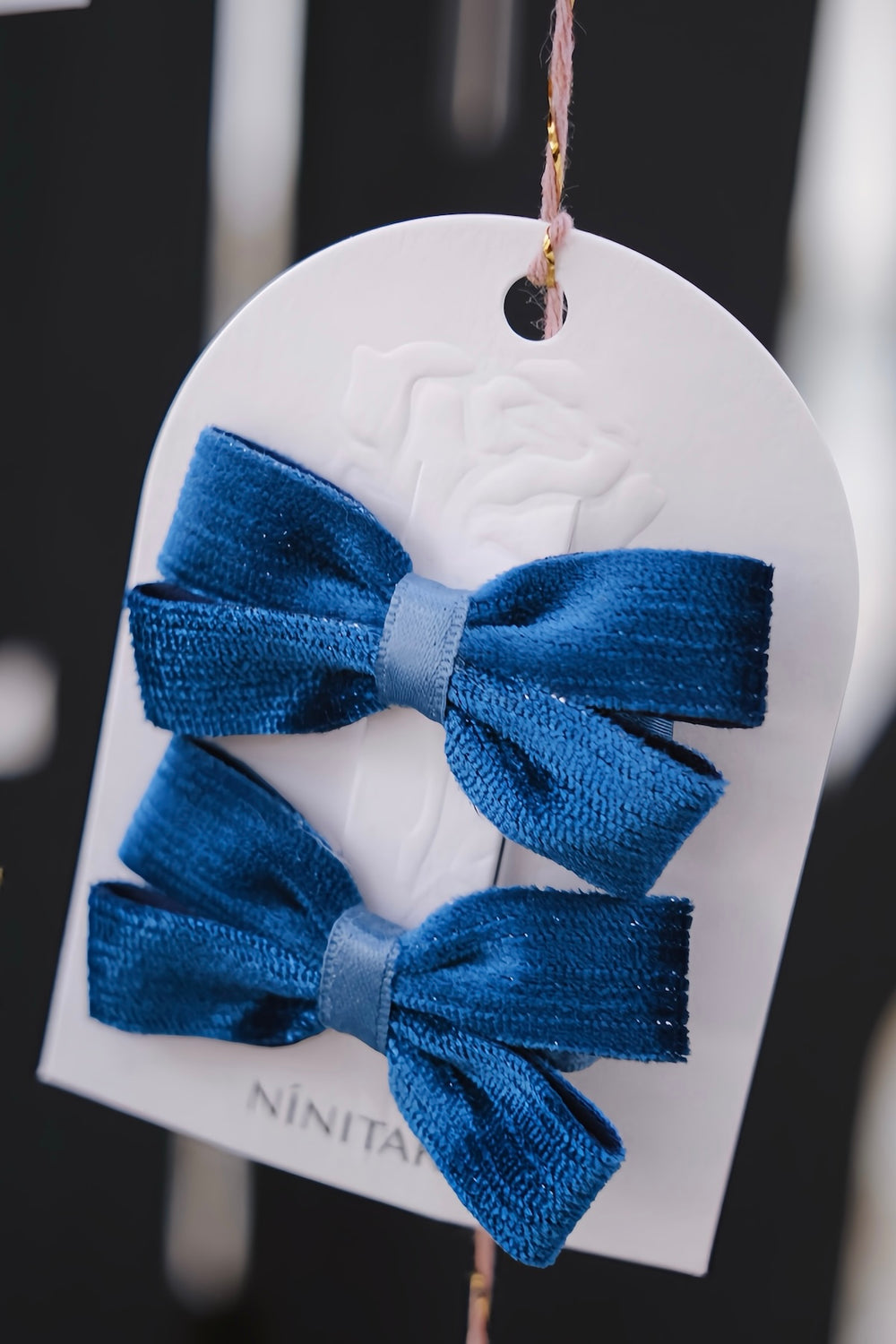 A pair of deep blue velvet hair clips, showcasing their rich, luxurious texture. Perfect for complementing winter outfits and holiday parties.