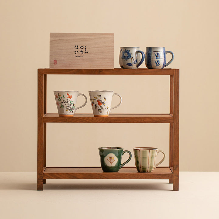 The warmth and inviting nature of the Oriental Bloom cup set, together with two other sets, are illustrated in this image. The comfortable grip and the enchanting floral designs make these cups perfect for sharing special moments with loved ones.