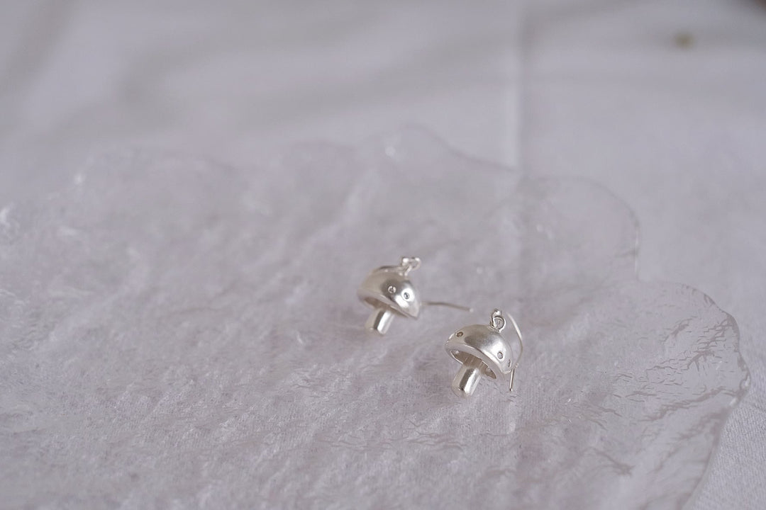 Side view of the sterling silver mushroom earrings, highlighting their intricate details and quality craftsmanship.