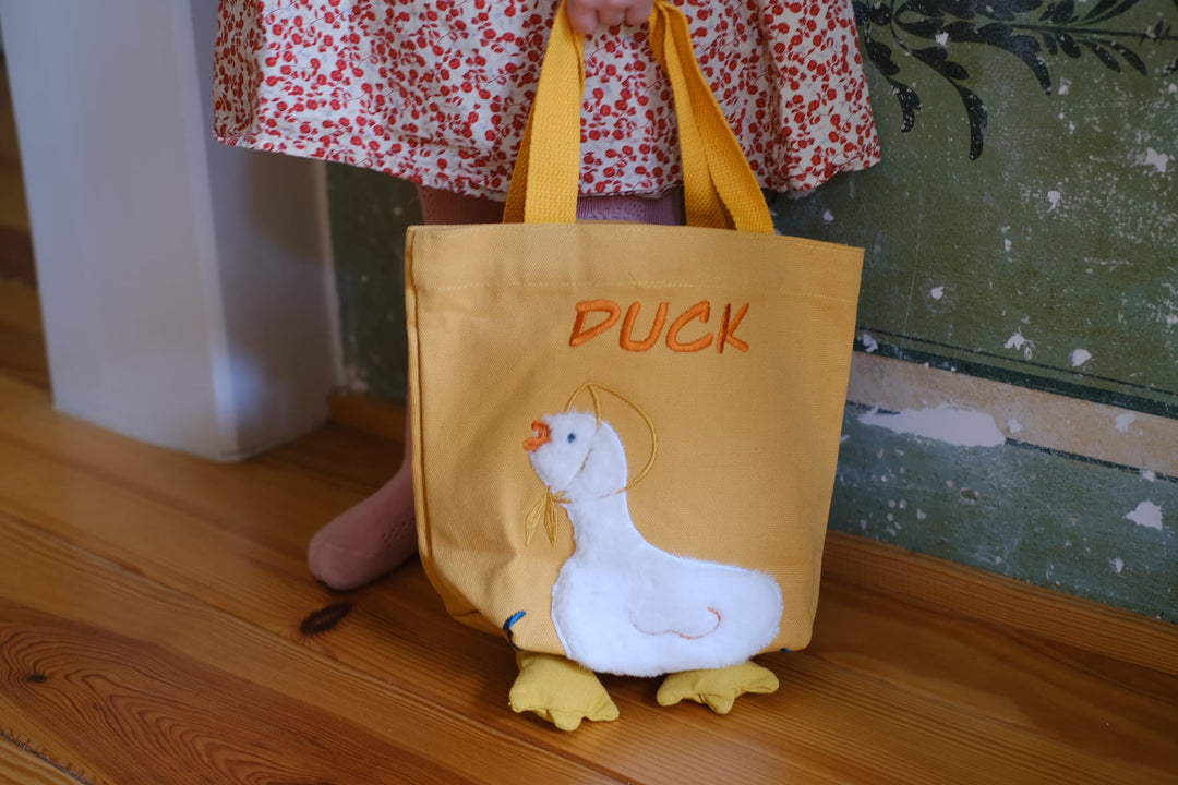 The bag being carried by a child, illustrating its size and how it complements a fun, playful outfit.