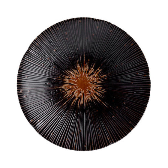 Detailed image of the black ceramic plate, highlighting the silver radial pattern and the elegant, glossy surface.