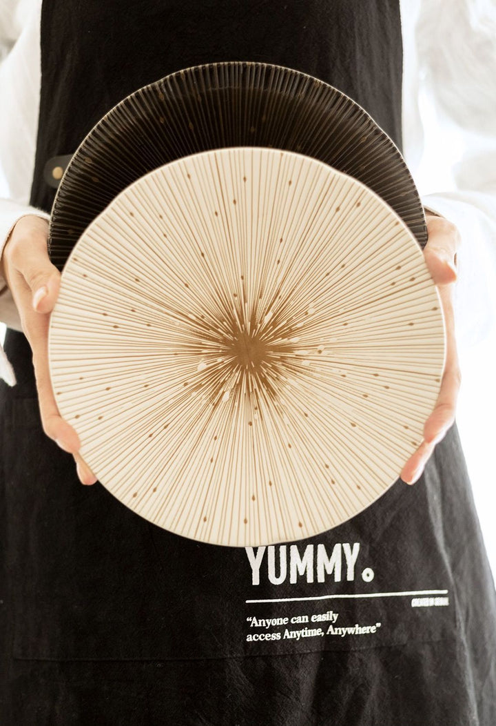 The white and black plates held together, highlighting the contrasting yet complementary designs.