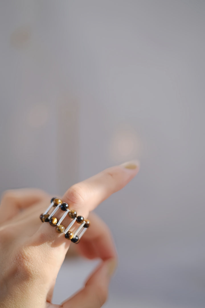 Crafted with sterling silver, this ring is designed to complement a variety of finger sizes while adding a touch of golden elegance to any outfit.