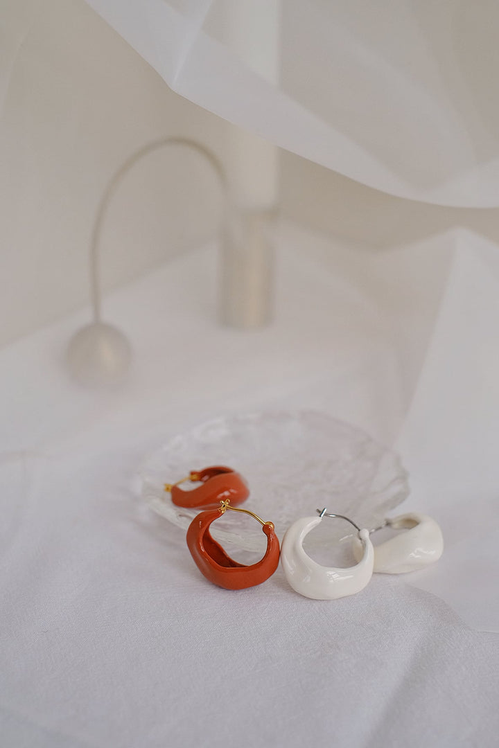 The unique design and high-quality materials make these hoop earrings a timeless accessory that you'll reach for time and time again.