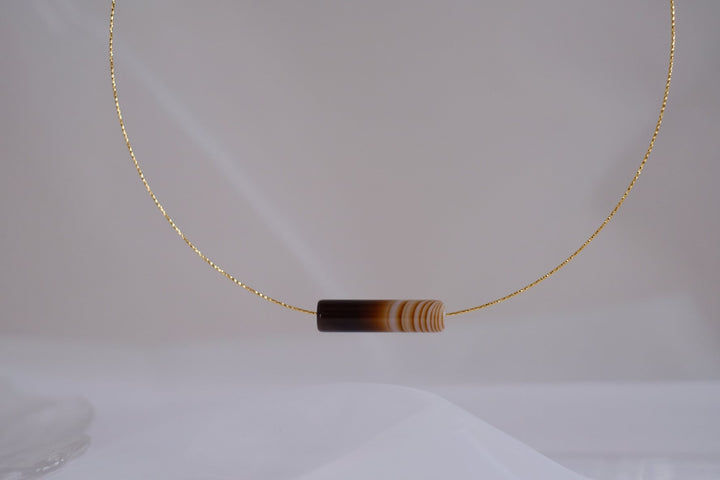Close-up of the Latte choker with its caramel-colored onyx pendant.