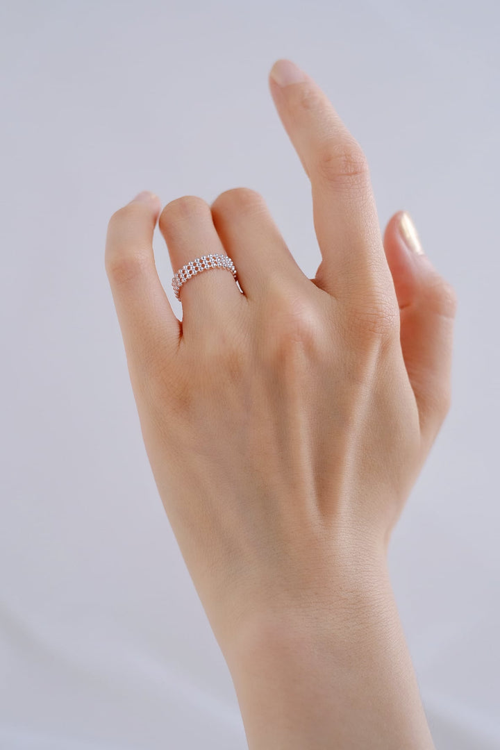This sterling silver ring offers a clean, band-like look, yet boasts intricate details that set it apart from a common band.