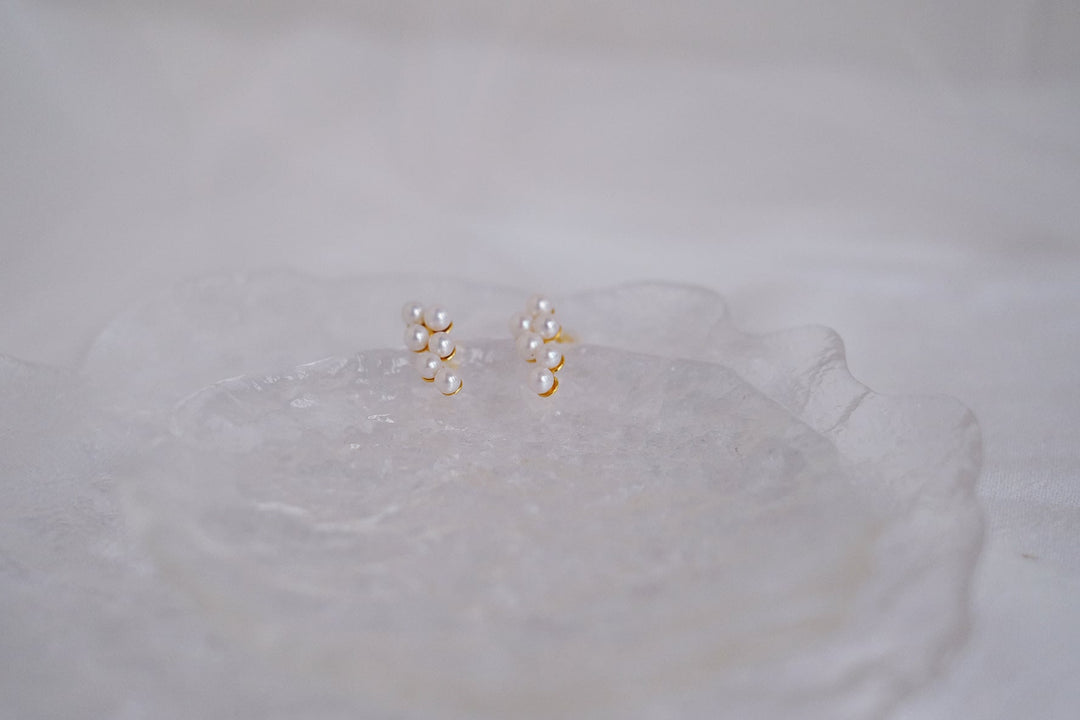 Six small Akoya pearls are delicately arranged on an 18k gold plated sterling silver base.