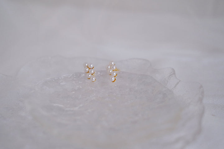 Six small Akoya pearls are delicately arranged on an 18k gold plated sterling silver base.