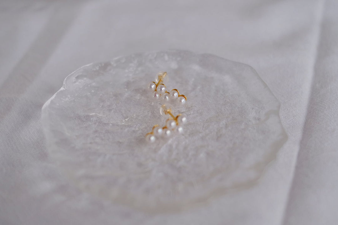 Detailed shot of our dainty Akoya pearl earrings, crafted with 18k gold plated sterling silver for a timeless and elegant finish.