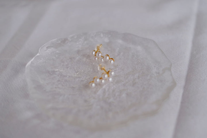 Detailed shot of our dainty Akoya pearl earrings, crafted with 18k gold plated sterling silver for a timeless and elegant finish.