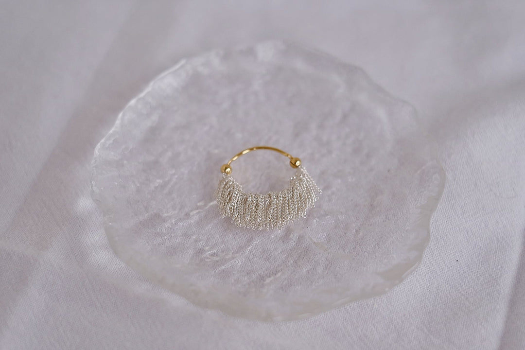 A close-up of the intricate craftsmanship and flowing tassels, capturing the elegance and sophistication of the design.