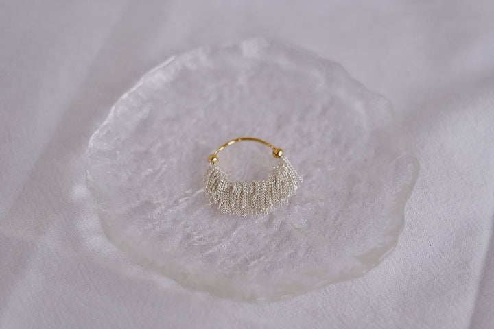 A close-up of the intricate craftsmanship and flowing tassels, capturing the elegance and sophistication of the design.