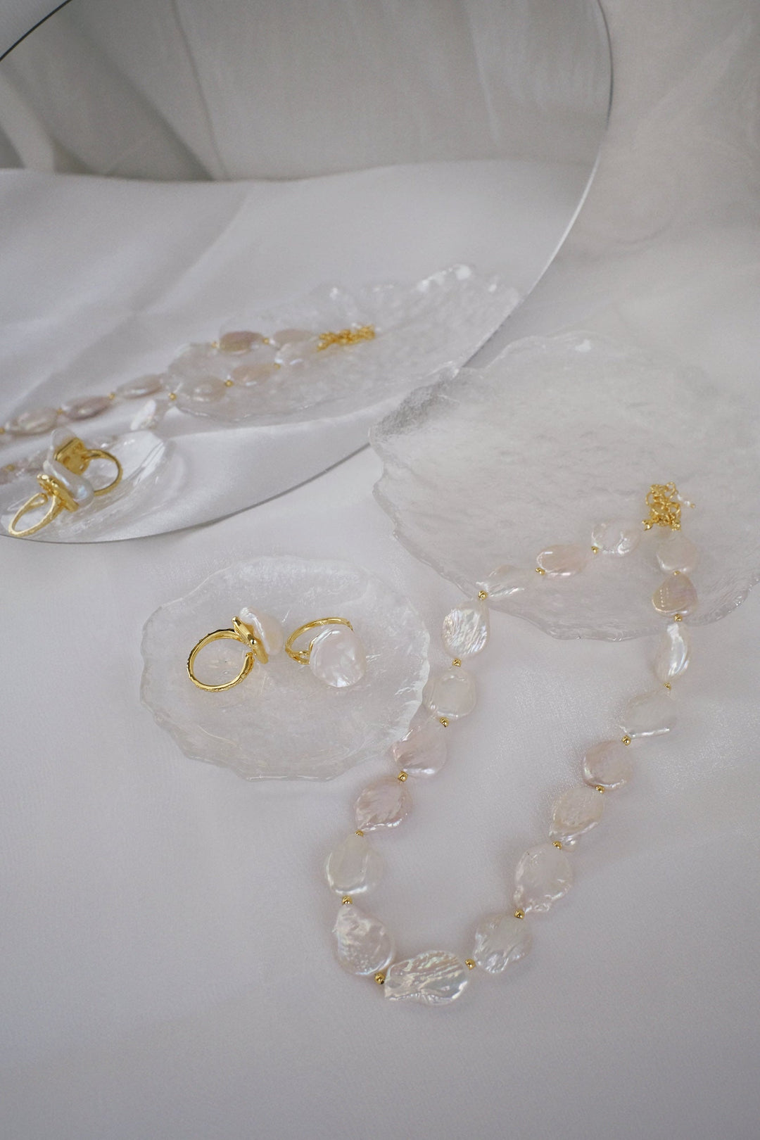 Pair the rings with the Moon coin pearl necklace for a coordinated and sophisticated look.