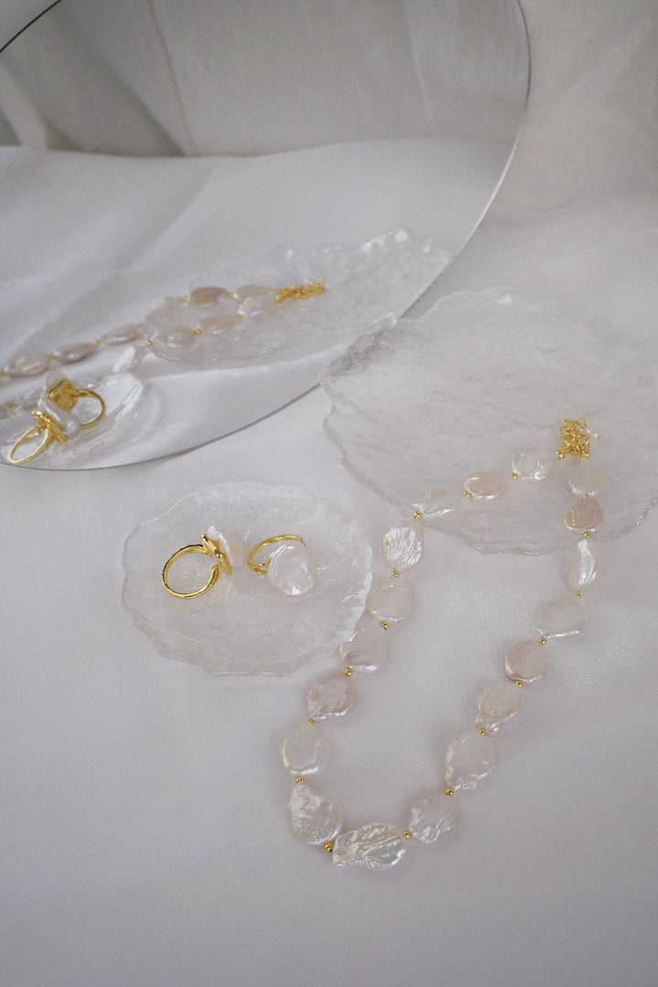 Pair the rings with the Moon coin pearl necklace for a coordinated and sophisticated look.