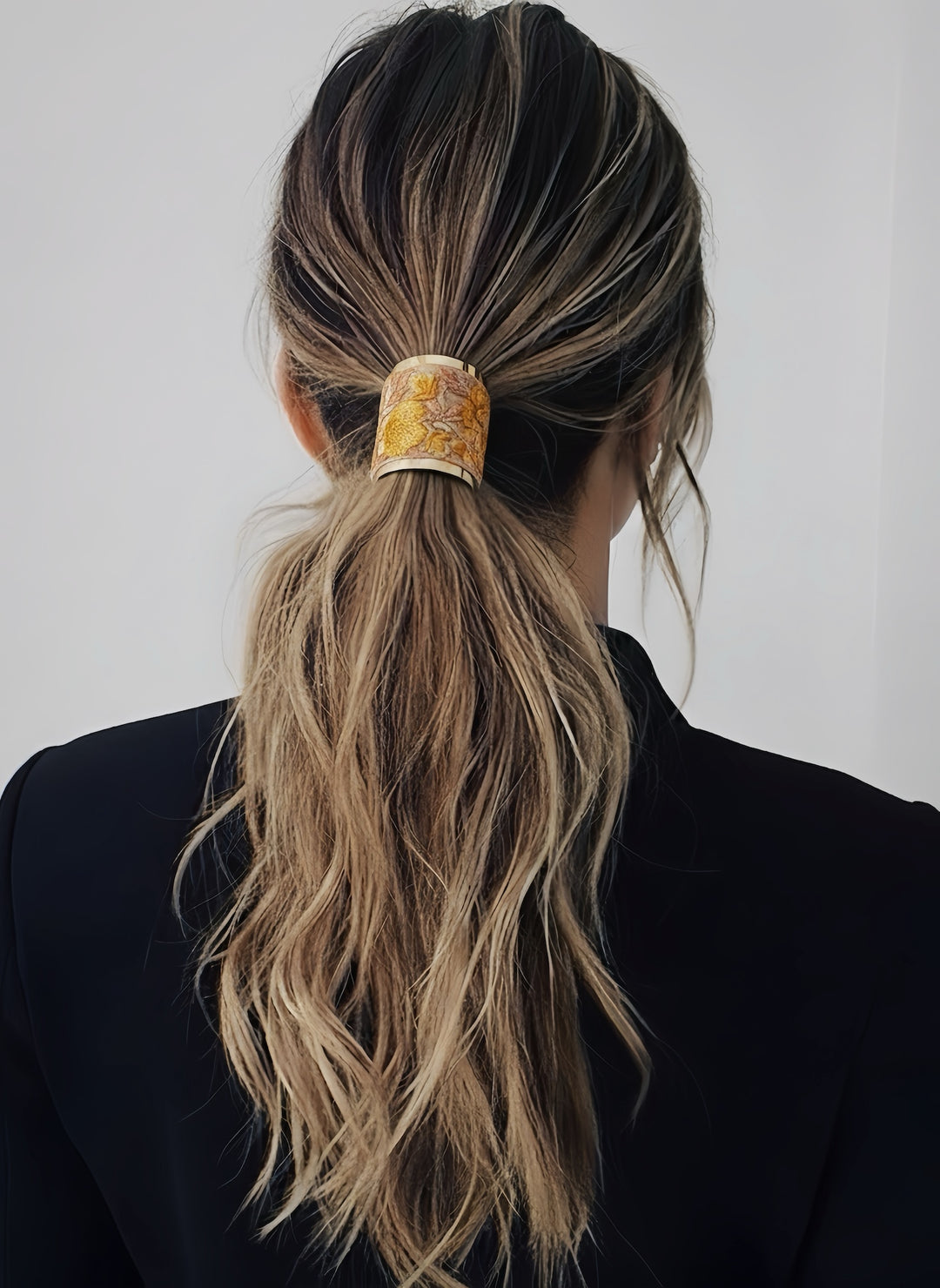 Back view of a woman wearing the embroidered hair wrap in a low ponytail, showcasing the intricate Indian embroidery.
