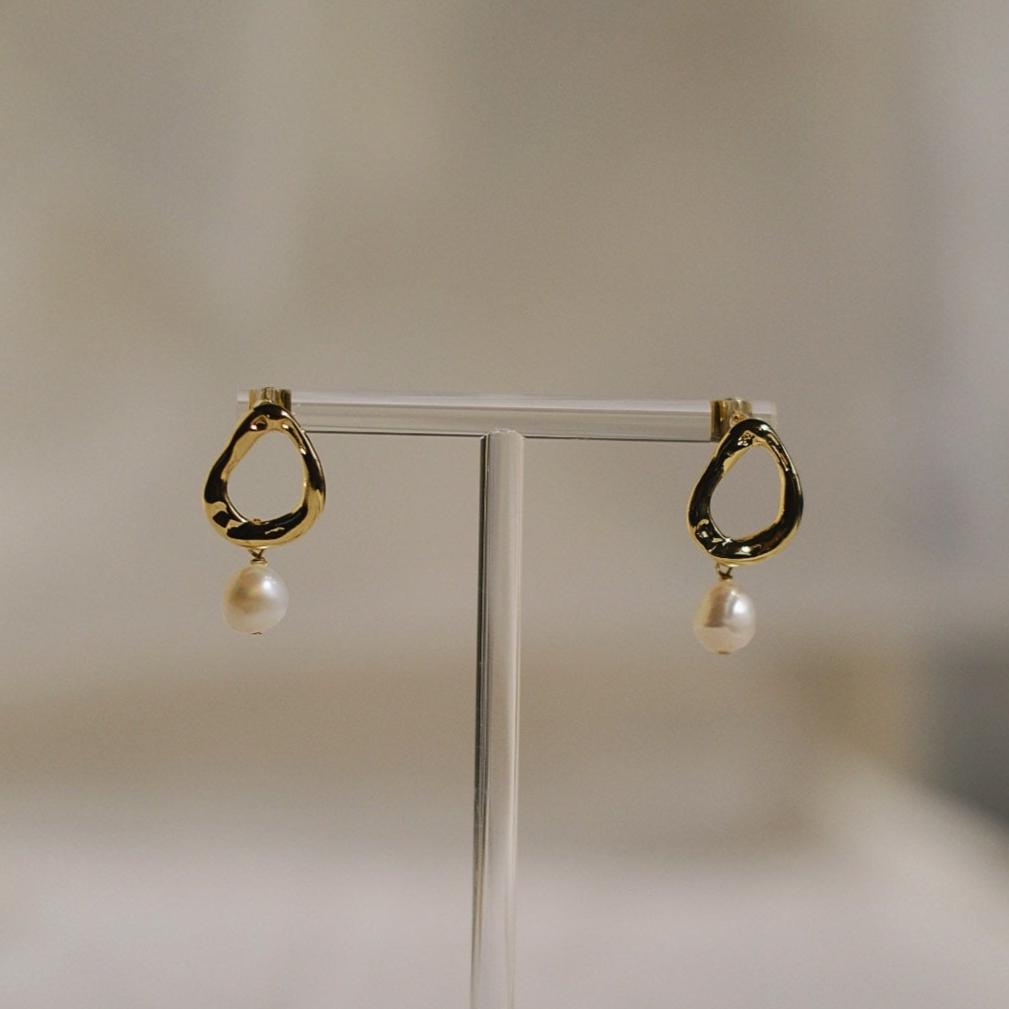 A detailed view of the Golden Harmony Pearl Earrings, highlighting the 7-8mm baroque freshwater pearls and the organically shaped gold-filled brass elements.