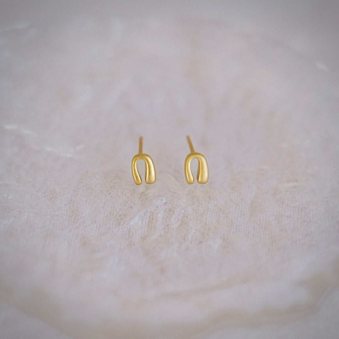 A pair of Mini Horseshoe earrings in gold-plated sterling silver.