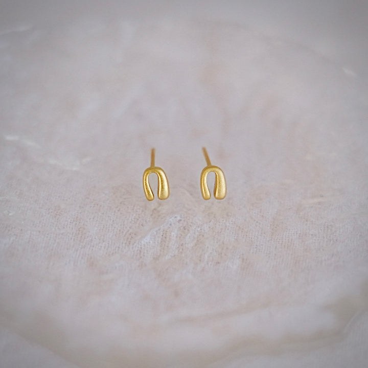A pair of Mini Horseshoe earrings in gold-plated sterling silver.