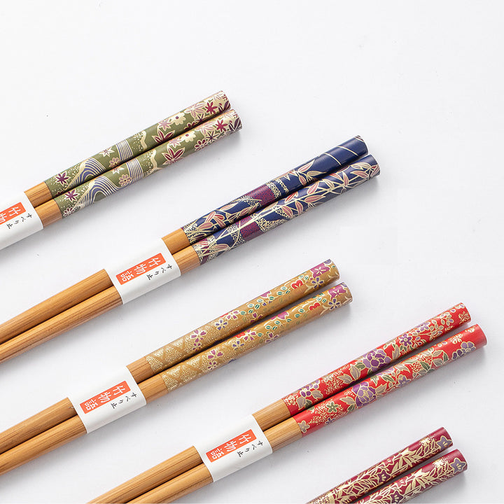 Close-up of the floral patterns on the handles of the chopsticks, showcasing intricate details and vibrant colors.
