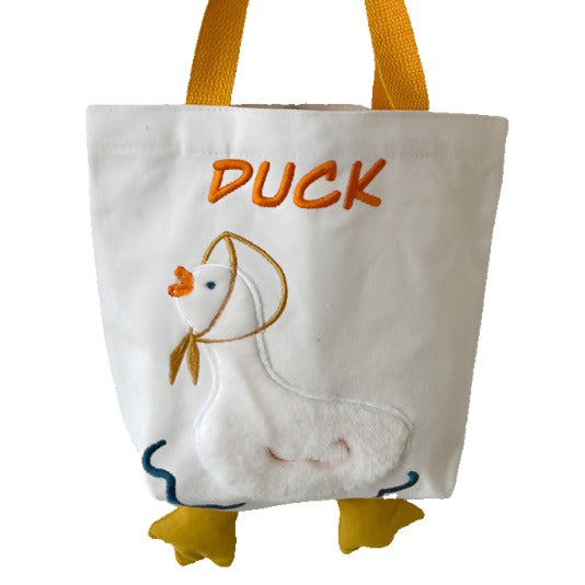 A cute tote bag with duck embroidery in a classic white color with bright yellow accents.