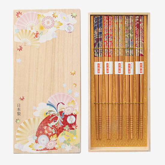 The chopsticks set displayed in a beautifully decorated gift box, emphasizing its elegant presentation.
