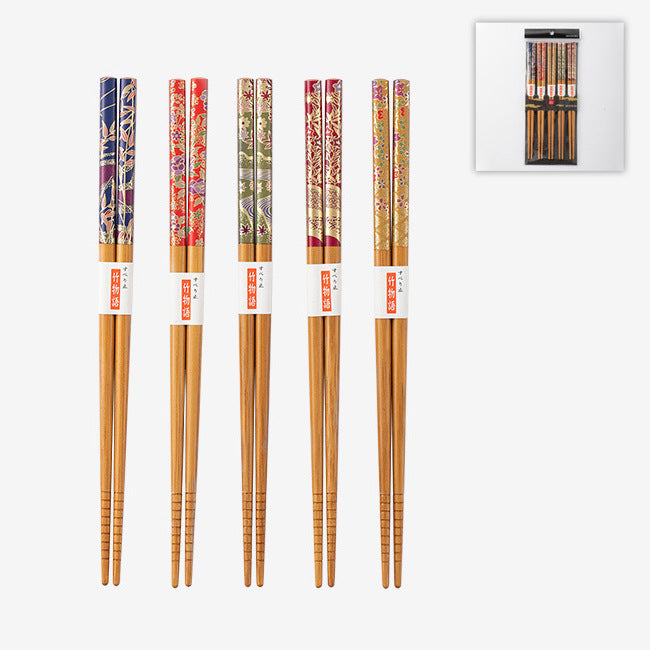 A set of 5 pairs of handcrafted Japanese wood chopsticks with floral designs, and the basic packaging.