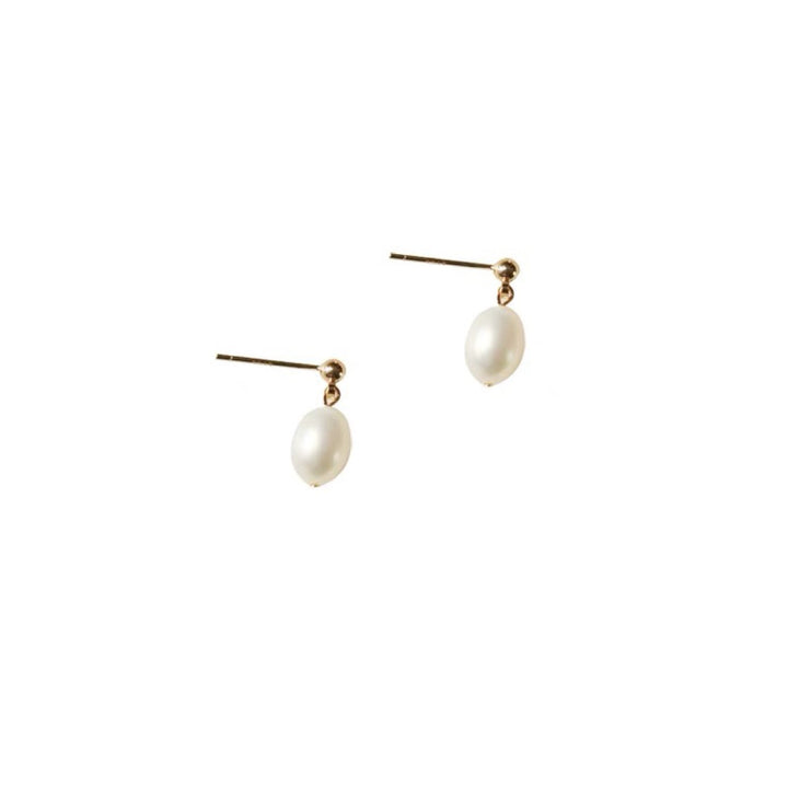A side perspective of the Petite Pearl Drop Earrings, focusing on their simple yet sophisticated drop design.