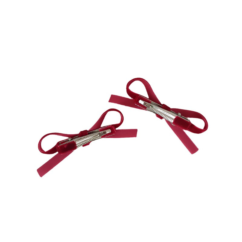 Close-up view of the secure metal alligator clips, highlighting the sturdy design that ensures these bows stay put all day.