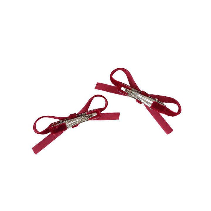 Close-up view of the secure metal alligator clips, highlighting the sturdy design that ensures these bows stay put all day.