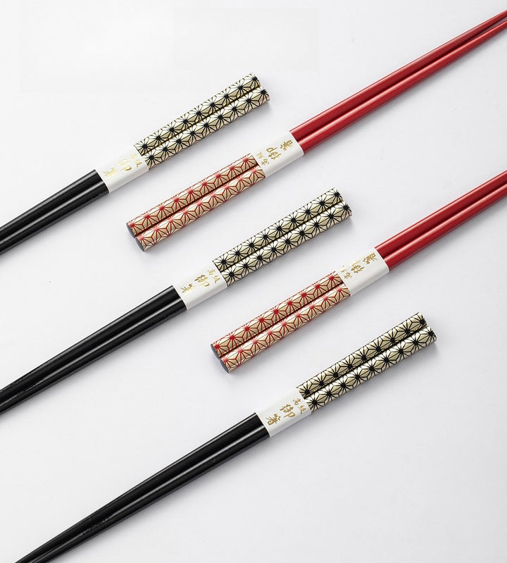 A detailed close-up of the sakura pattern on the chopstick handles, showcasing the fine craftsmanship and elegant design.