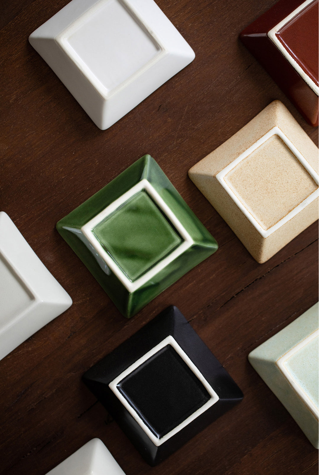 A photograph highlighting the bottoms of the plates, revealing the artisanship and craftsmanship in the design and texture of the ceramic, emphasizing the quality and attention to detail.