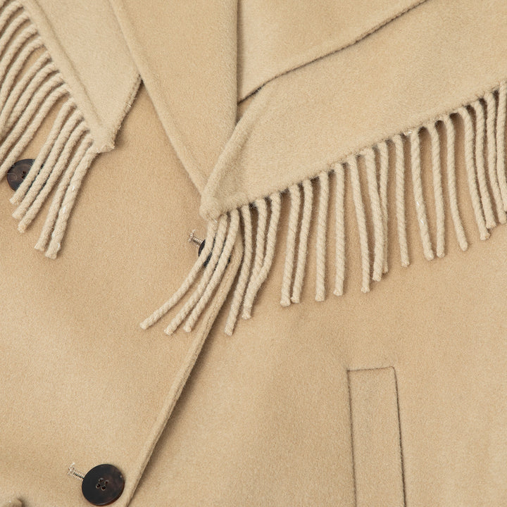 Close-up view of the fringe scarf, highlighting its intricate details and luxurious wool texture.